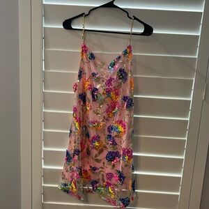 Sequin mini cocktail dress with a cowl neck and gold chain straps.